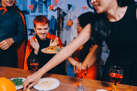 Joyful office Halloween party with coworkers in costumes, celebrating with drinks and laughter, fostering teamwork and festive spiritの写真素材
