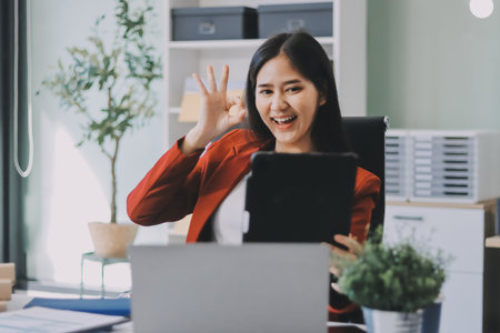 Beautiful young woman working using touchpad tabletの写真素材