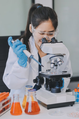 Portrait, science and woman on laptop in lab to research chemistry, test or innovation. Microscope, scientist and face of medical doctor in goggles for microbiology, healthcare or pharma studyの写真素材