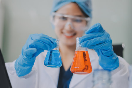 Portrait, science and happy woman on laptop in lab to research chemistry, test or innovation. Microscope, scientist and face of medical doctor in goggles for microbiology, healthcare or pharma studyの写真素材
