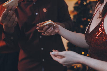 Festive Office Christmas Party with Delicious Food. A beautifully decorated office space with Christmas trees and festive lights, set up for a holiday party.の写真素材