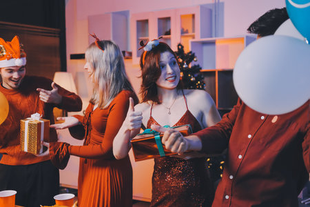 Festive Office Christmas Party with Delicious Food. A beautifully decorated office space with Christmas trees and festive lights, set up for a holiday party.の写真素材