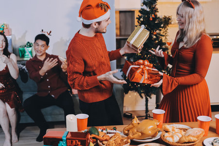 Festive Office Christmas Party with Delicious Food. A beautifully decorated office space with Christmas trees and festive lights, set up for a holiday party.の写真素材