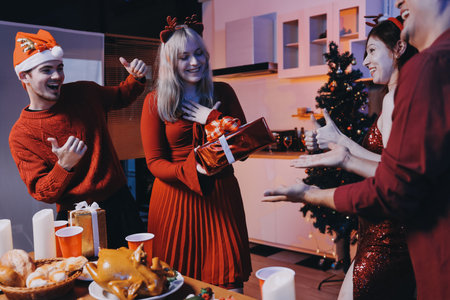 Festive Office Christmas Party with Delicious Food. A beautifully decorated office space with Christmas trees and festive lights, set up for a holiday party.の写真素材