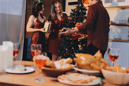 Festive Office Christmas Party with Delicious Food. A beautifully decorated office space with Christmas trees and festive lights, set up for a holiday party.の写真素材