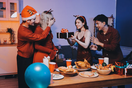 Festive Office Christmas Party with Delicious Food. A beautifully decorated office space with Christmas trees and festive lights, set up for a holiday party.の写真素材