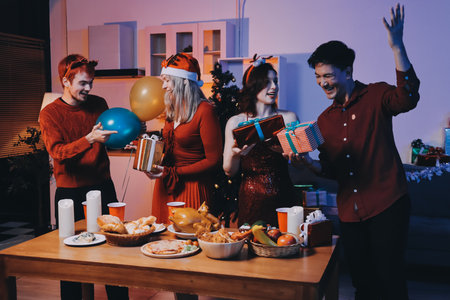 Festive Office Christmas Party with Delicious Food. A beautifully decorated office space with Christmas trees and festive lights, set up for a holiday party.の写真素材