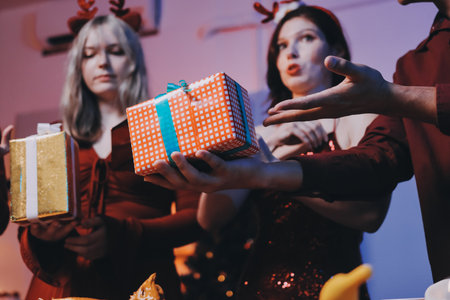 Festive Office Christmas Party with Delicious Food. A beautifully decorated office space with Christmas trees and festive lights, set up for a holiday party.の写真素材