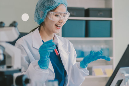 Portrait, science and happy woman on laptop in lab to research chemistry, test or innovation. Microscope, scientist and face of medical doctor in goggles for microbiology, healthcare or pharma studyの写真素材