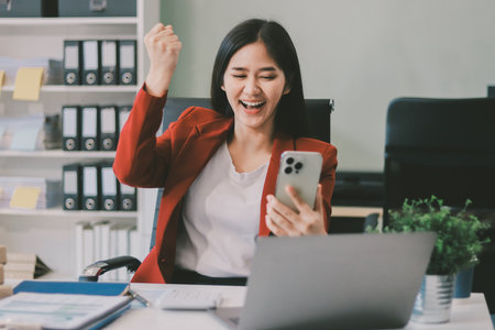 Asian business woman working on a laptop in a professional officeの写真素材