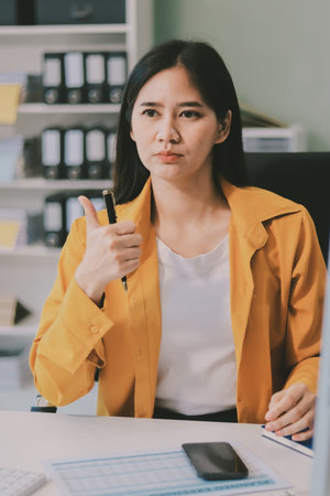 Business woman using calculator for do math finance on wooden desk in office and business working background, tax, accounting, statistics and analytic research concept.の写真素材