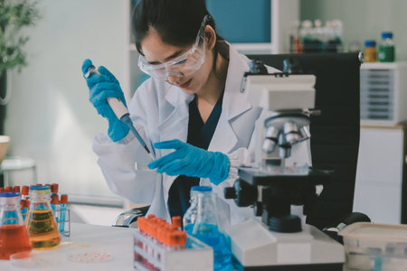 Portrait, science and happy woman on laptop in lab to research chemistry, test or innovation. Microscope, scientist and face of medical doctor in goggles for microbiology, healthcare or pharma studyの写真素材