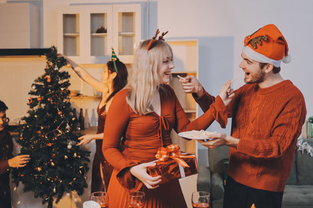 Festive Office Christmas Party with Delicious Food. A beautifully decorated office space with Christmas trees and festive lights, set up for a holiday party.の写真素材