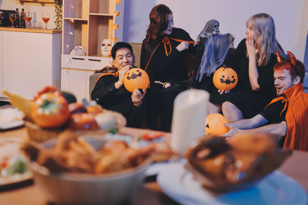 Friends enjoying a Halloween party making a toastの写真素材