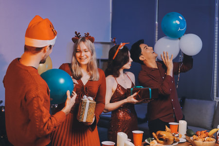 Festive Office Christmas Party with Delicious Food. A beautifully decorated office space with Christmas trees and festive lights, set up for a holiday party.の写真素材