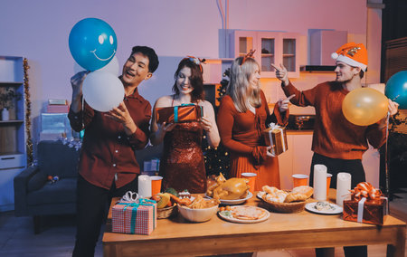 Festive Office Christmas Party with Delicious Food. A beautifully decorated office space with Christmas trees and festive lights, set up for a holiday party.の写真素材