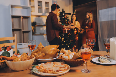 Festive Office Christmas Party with Delicious Food. A beautifully decorated office space with Christmas trees and festive lights, set up for a holiday party.の写真素材