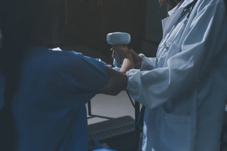 Physical therapist assisting a woman with dumbbell exerciseの写真素材
