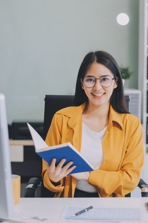 Business woman using calculator for math finance on wooden desk in office and business working...