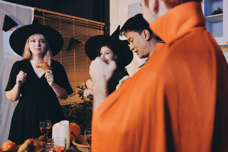 Friends enjoying a Halloween party making a toastの写真素材