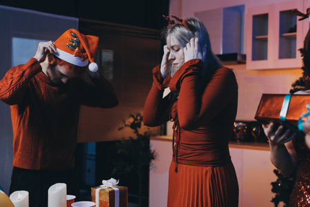 Festive Office Christmas Party with Delicious Food. A beautifully decorated office space with Christmas trees and festive lights, set up for a holiday party.の写真素材