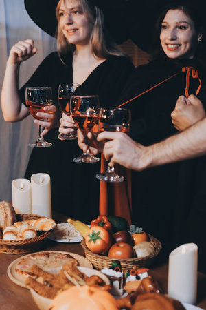 Friends enjoying a Halloween party making a toastの写真素材