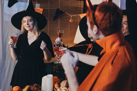 Friends enjoying a Halloween party at a bar making a toast