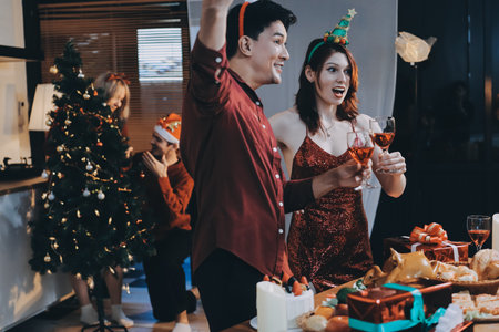 Festive Office Christmas Party with Delicious Food. A beautifully decorated office space with Christmas trees and festive lights, set up for a holiday party.の写真素材