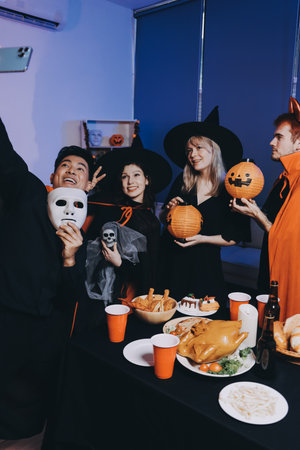 Friends enjoying a Halloween party making a toastの写真素材