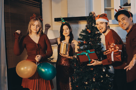 Festive Office Christmas Party with Delicious Food. A beautifully decorated office space with Christmas trees and festive lights, set up for a holiday party.の写真素材