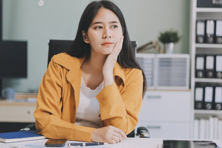Business woman using calculator for do math finance on wooden desk in office and business working background, tax, accounting, statistics and analytic research concept.の写真素材