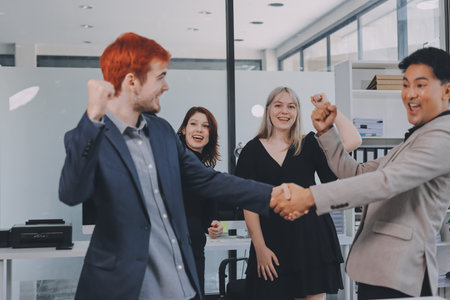 Meeting, partnership and business people shaking hands in the office for a deal, collaboration or onboarding. Diversity, professional and employees with handshake for agreement, welcome or greeting.の写真素材