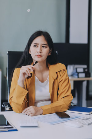 Business woman using calculator for do math finance on wooden desk in office and business working background, tax, accounting, statistics and analytic research concept.の写真素材