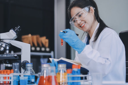 Portrait, science and happy woman on laptop in lab to research chemistry, test or innovation....
