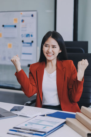 Asian business woman working on a laptop in a professional officeの写真素材