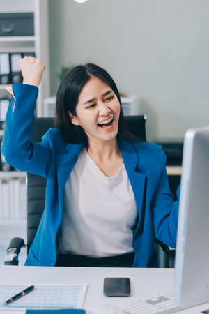 Asian business woman working on a laptop in a professional officeの写真素材