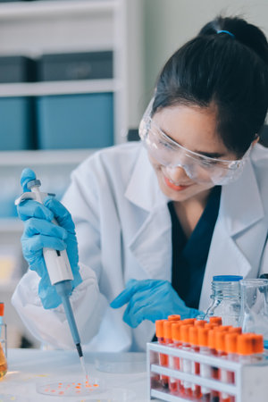 Portrait, science and happy woman on laptop in lab to research chemistry, test or innovation. Microscope, scientist and face of medical doctor in goggles for microbiology, healthcare or pharma studyの写真素材