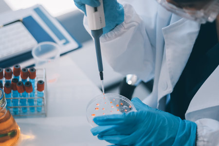 Portrait, science and happy woman on laptop in lab to research chemistry, test or innovation. Microscope, scientist and face of medical doctor in goggles for microbiology, healthcare or pharma studyの写真素材