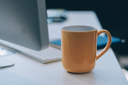 Wooden work desk with laptop and documents, books, modern interior of cozy cabinet, table for businessman or student at home, comfortable workspace, workplace with computer in apartmentの写真素材