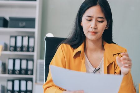 Headache, business woman at night and computer stress while working for a deadline. Sad corporate manager with anxiety about target working at desk screen late to complete task onlineの写真素材