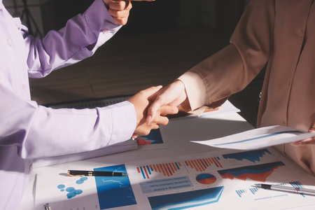 Above table with finance papers, graphs and big data during teamwork meeting with accounting or...