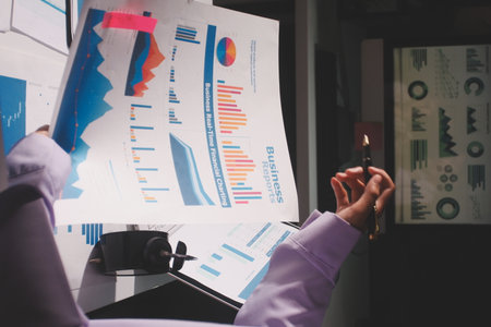 Above table with finance papers, graphs and big data during teamwork meeting with accounting or...