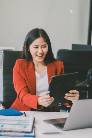 Beautiful young woman working using touchpad tabletの写真素材