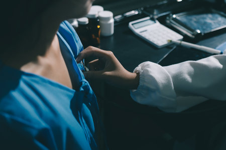 healthy concept; Doctor checking patient's heart with stethoscope at a hospital