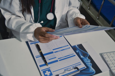 Doctor Explaining X-Ray Results to a Patient Using a Digital Device