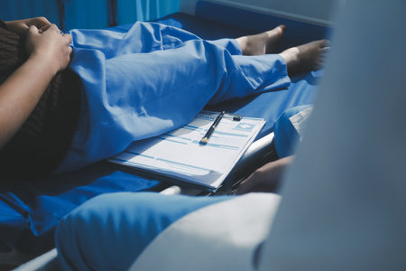 Man with abdominal pain, bloating, diarrhea goes to the doctor at medical clinic. Female doctor is...