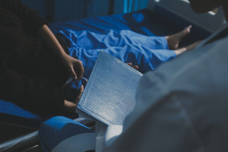Man with abdominal pain, bloating, diarrhea goes to the doctor at medical clinic. Female doctor is diagnosing a patient abdominal pain in the examination room at the hospital.の写真素材