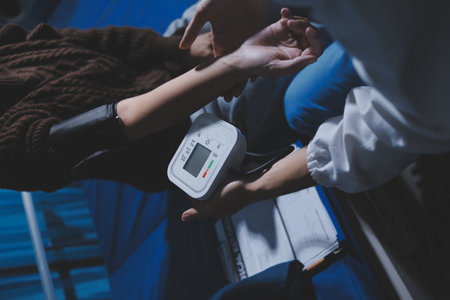 The doctor measures blood pressure to the patient