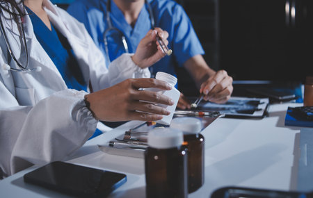 Doctors are meeting at the hospital to discuss treatment options and share experiences with colleagues.の写真素材