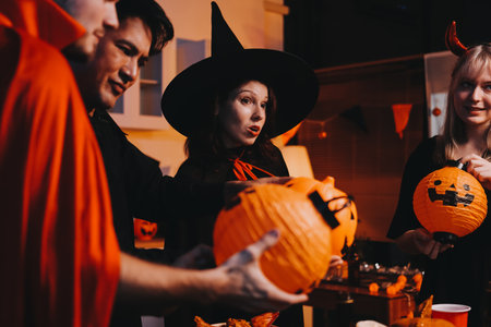 Friends enjoying a Halloween party making a toastの写真素材